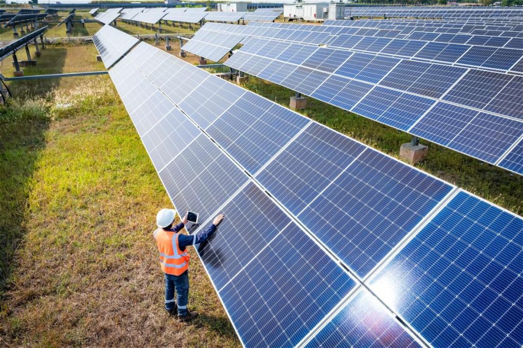 Technicien inspectant panneaux solaires